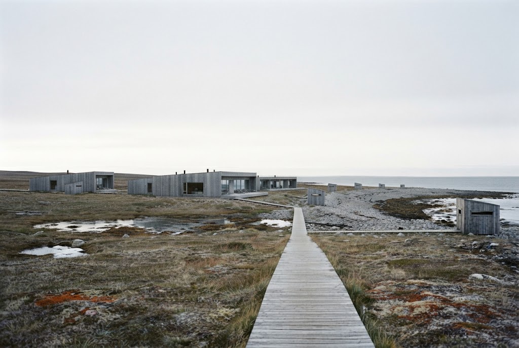 Artist's impression of the planned resort seen from the tundra: low timber buildings, a boardwalk across the heath and the sea on the horizon