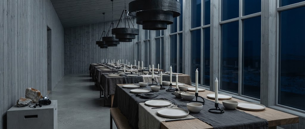 Artist's impression of a dinner in the planned long hall: candles on long tables and the polar night beyond panoramic windows