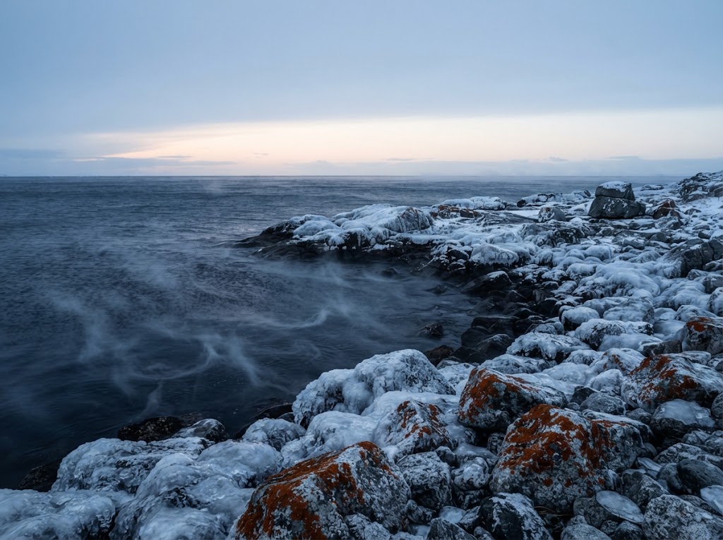 Artist's impression of a frozen shore with sea smoke rising in the blue light of the polar noon